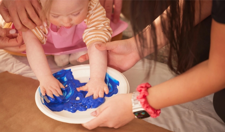 Child painting with a disability