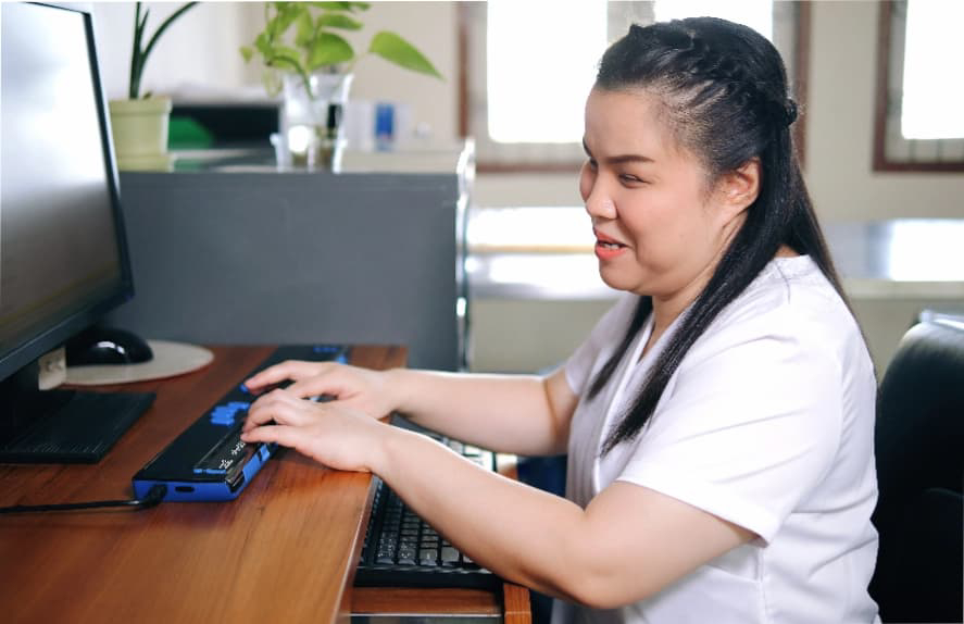 a man with downs syndrome holding a tablet