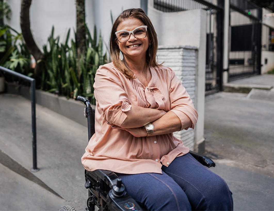 Lady in wheelchair outside apartment buildings